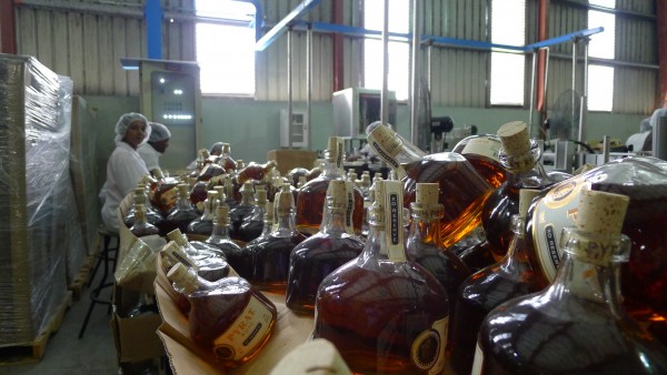 Hand Labeling Pyrat XO Reserve Rum at the Diamond Bottling plant in Guyana (Photo Credit Jamie Drummond)